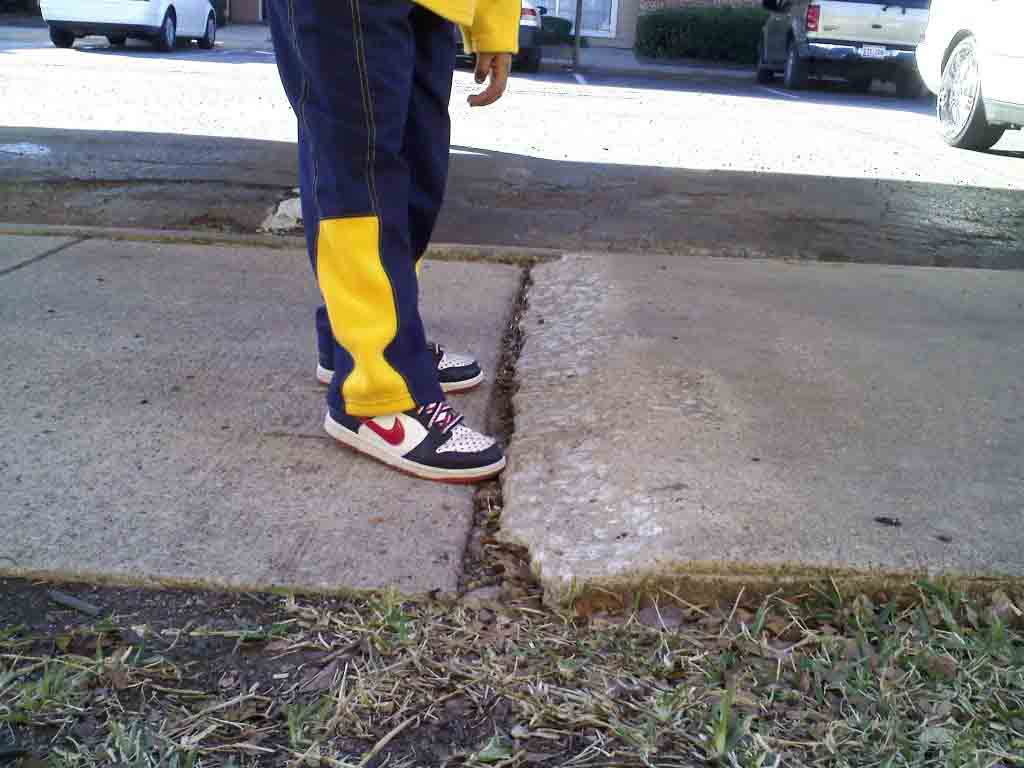man standing next to broken concrete
