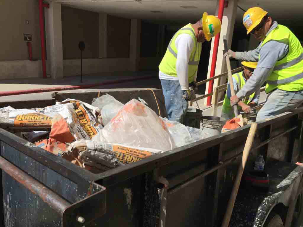 men hauling away debris