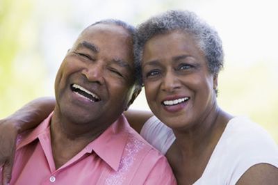 A senior couple smiling for the camera. 