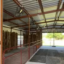 A large metal building with a basketball hoop inside of it.