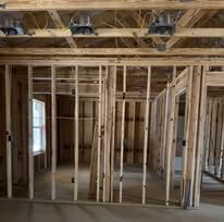 The inside of a house under construction with a lot of wooden beams.