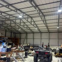 A warehouse filled with lots of vehicles and equipment.
