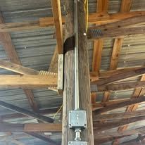 A wooden pole with a metal pipe attached to it.