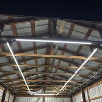 The ceiling of a building with a lot of lights hanging from it.