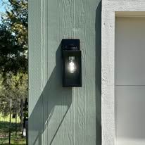 There is a light on the side of a building.