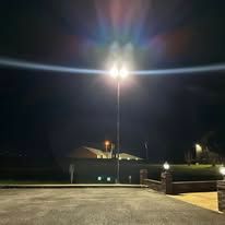 A parking lot with a lot of lights on at night.