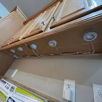A kitchen with wooden cabinets and a stove top oven.