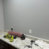 A bathroom counter with a lot of tools on it.