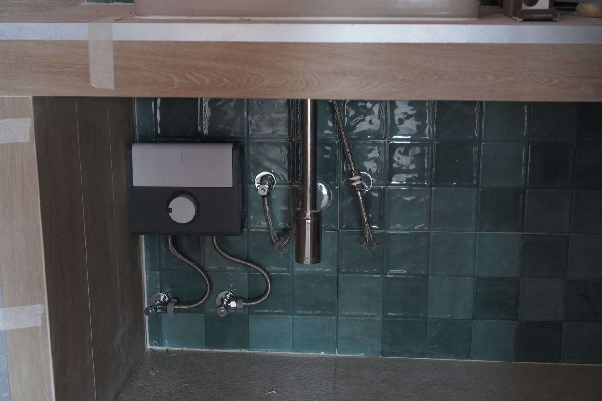 A bathroom sink with a black box underneath it