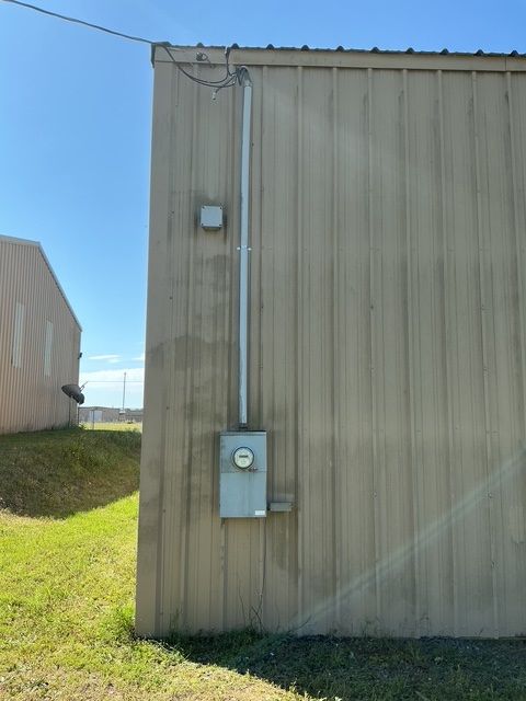 A building with a electrical box on the side of it.