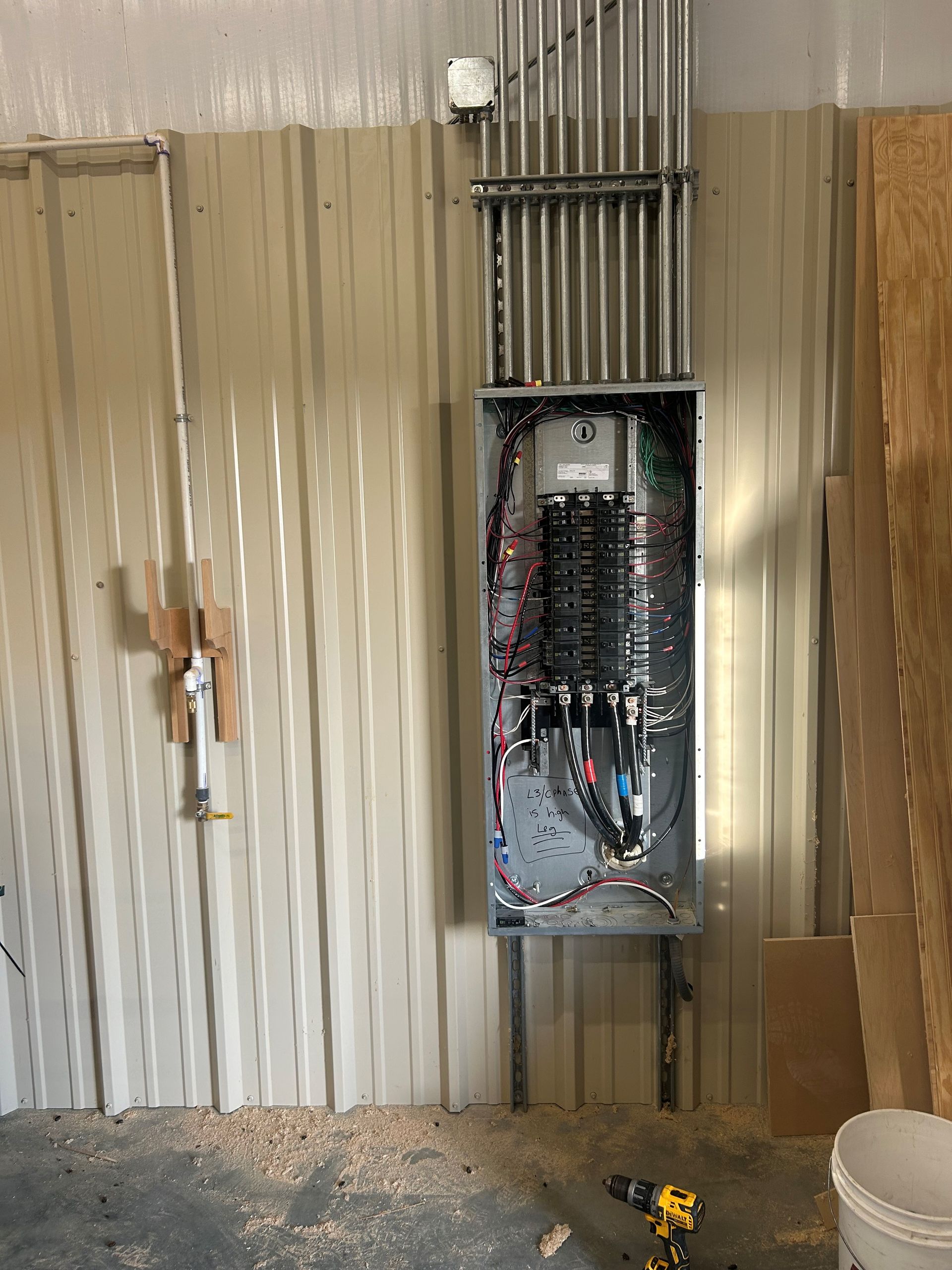 A large electrical box is hanging on a wall in a room.