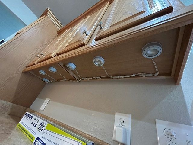A kitchen with wooden cabinets and a box on the counter