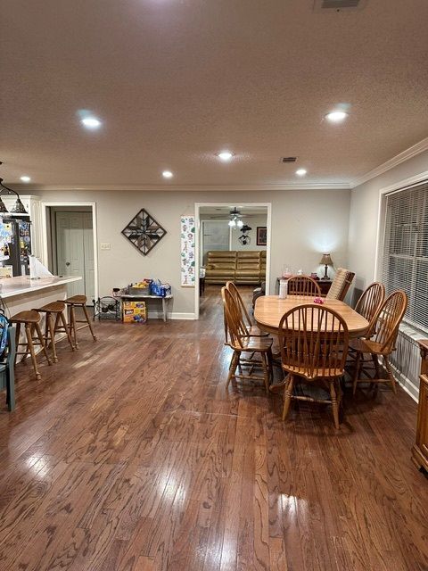 There is a table and chairs in the middle of the room.