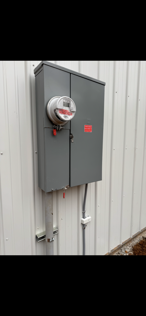 A meter is mounted on the side of a building.