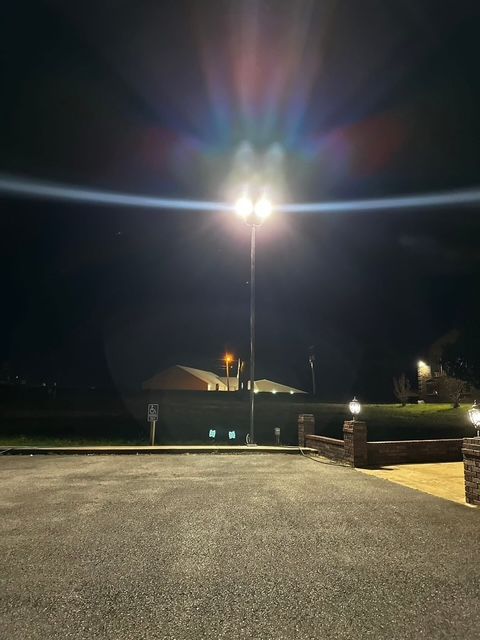 A parking lot at night with a lot of lights on