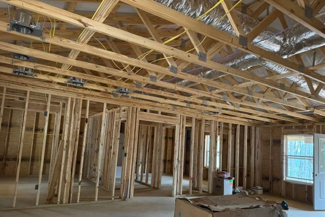 A house is being built with a lot of wooden beams.