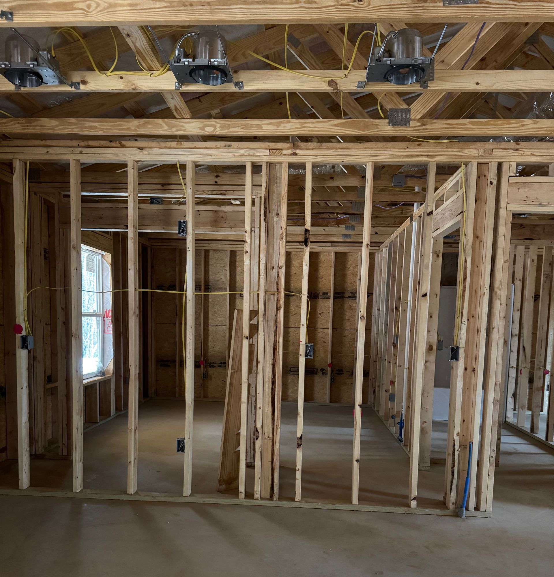 The inside of a house under construction with wooden beams