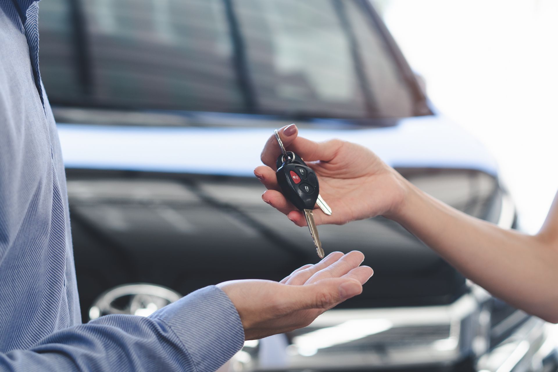 Two People Exchanging Car Keys in Front of a Vehicle — Murwillumbah Motor Wreckers in South Murwillumbah, NSW
