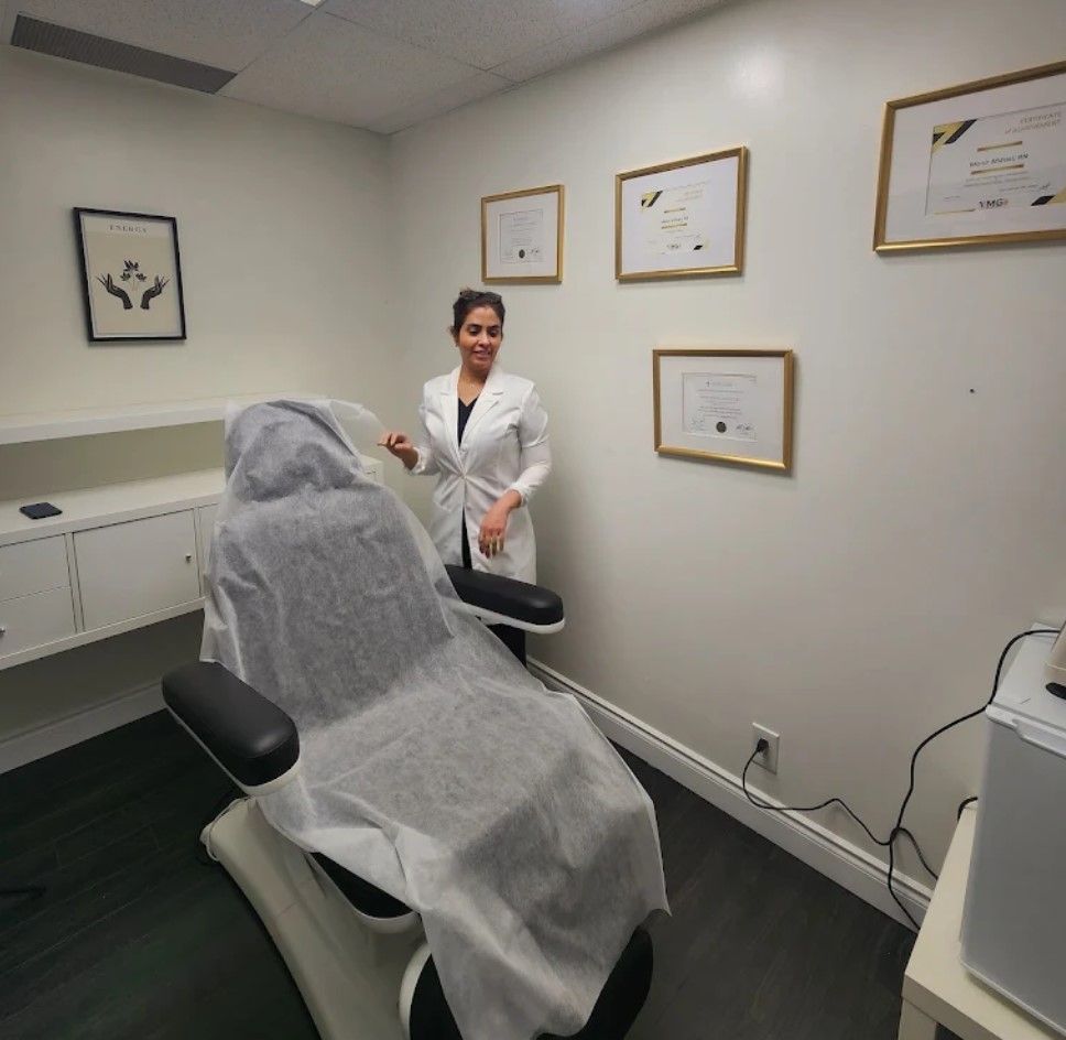 Clinic exam room with a patient under a drape and a doctor standing nearby