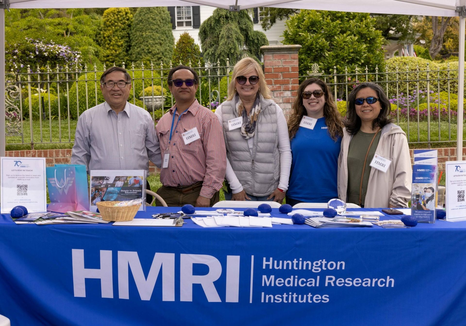 Five people at a blue table with