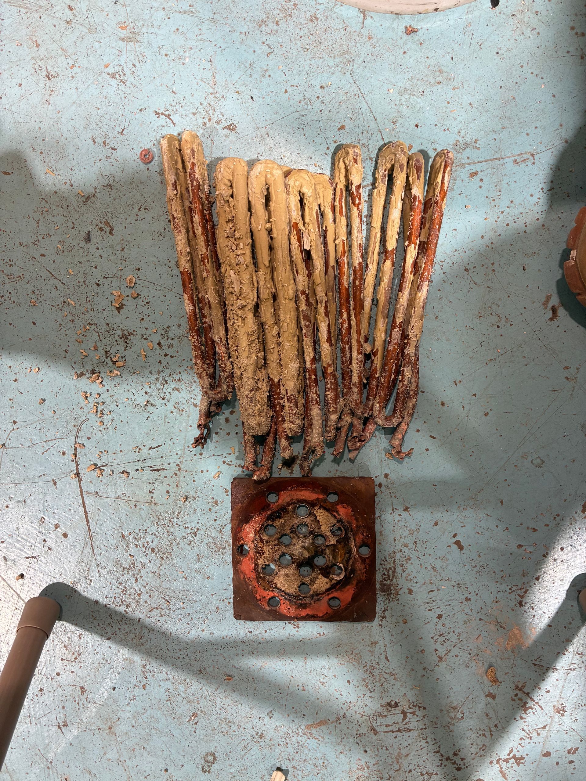 A bunch of sticks are sitting on a blue surface