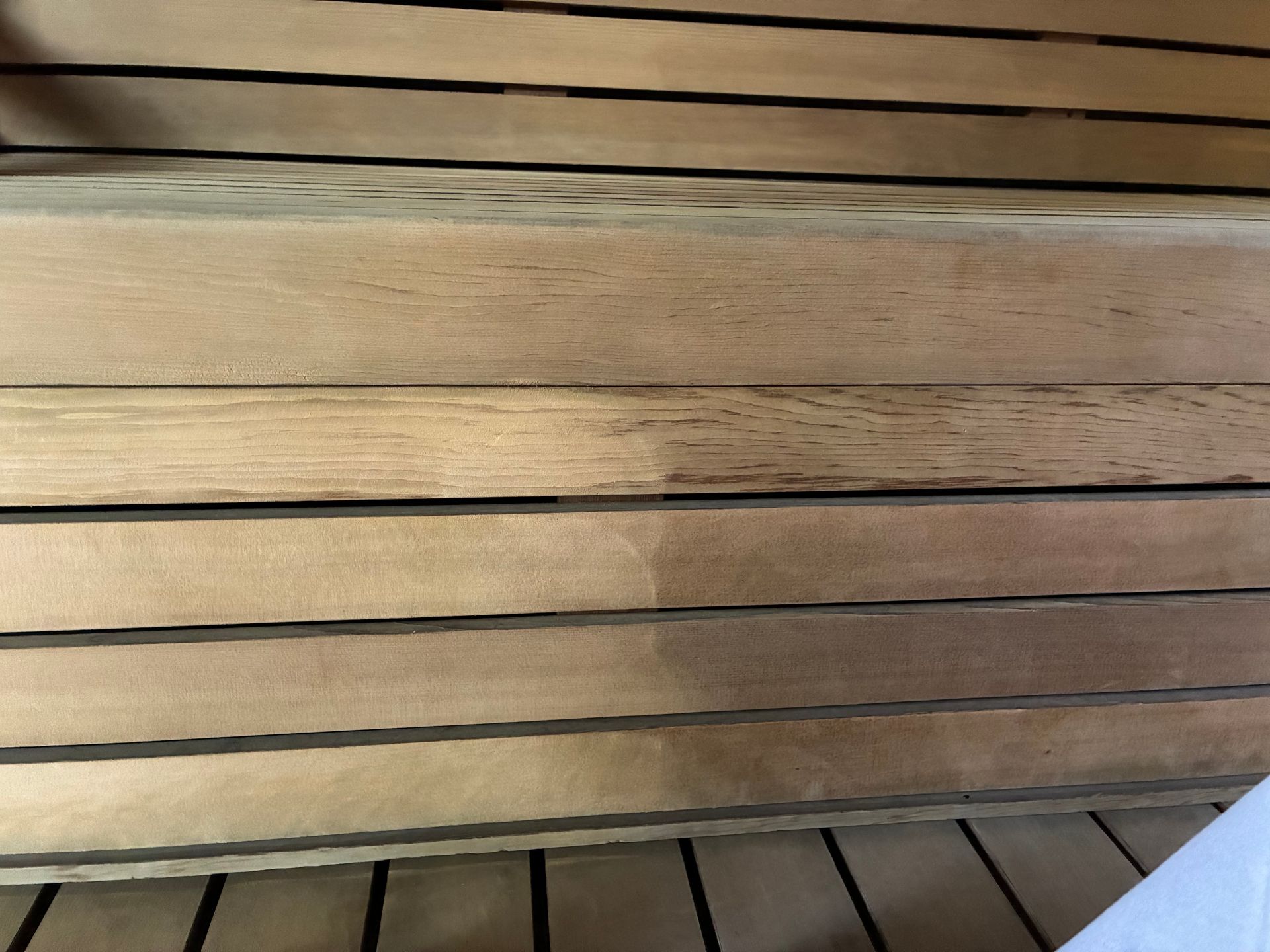 A close up of a wooden shelf with a stain on it