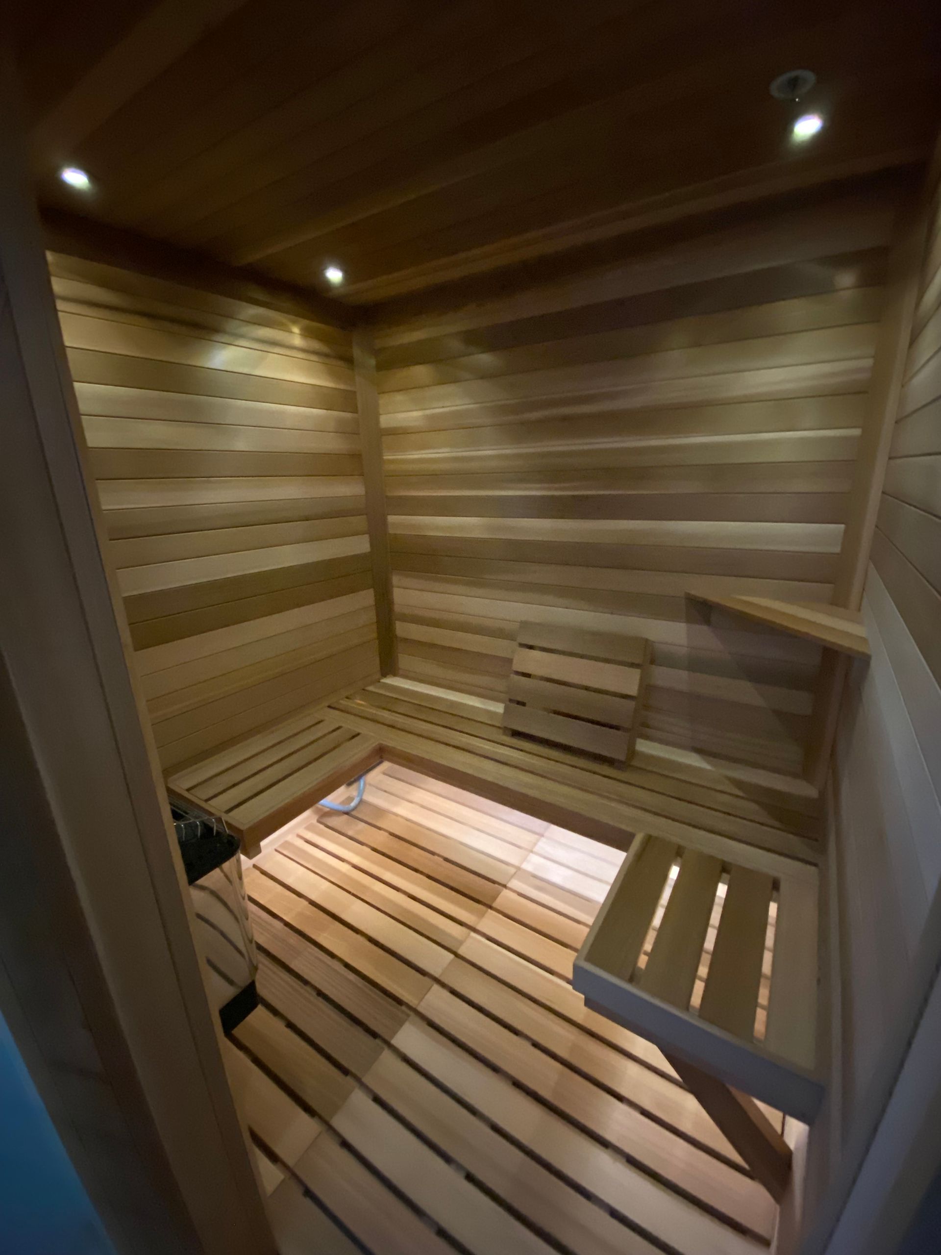 A wooden sauna with a bench in the middle