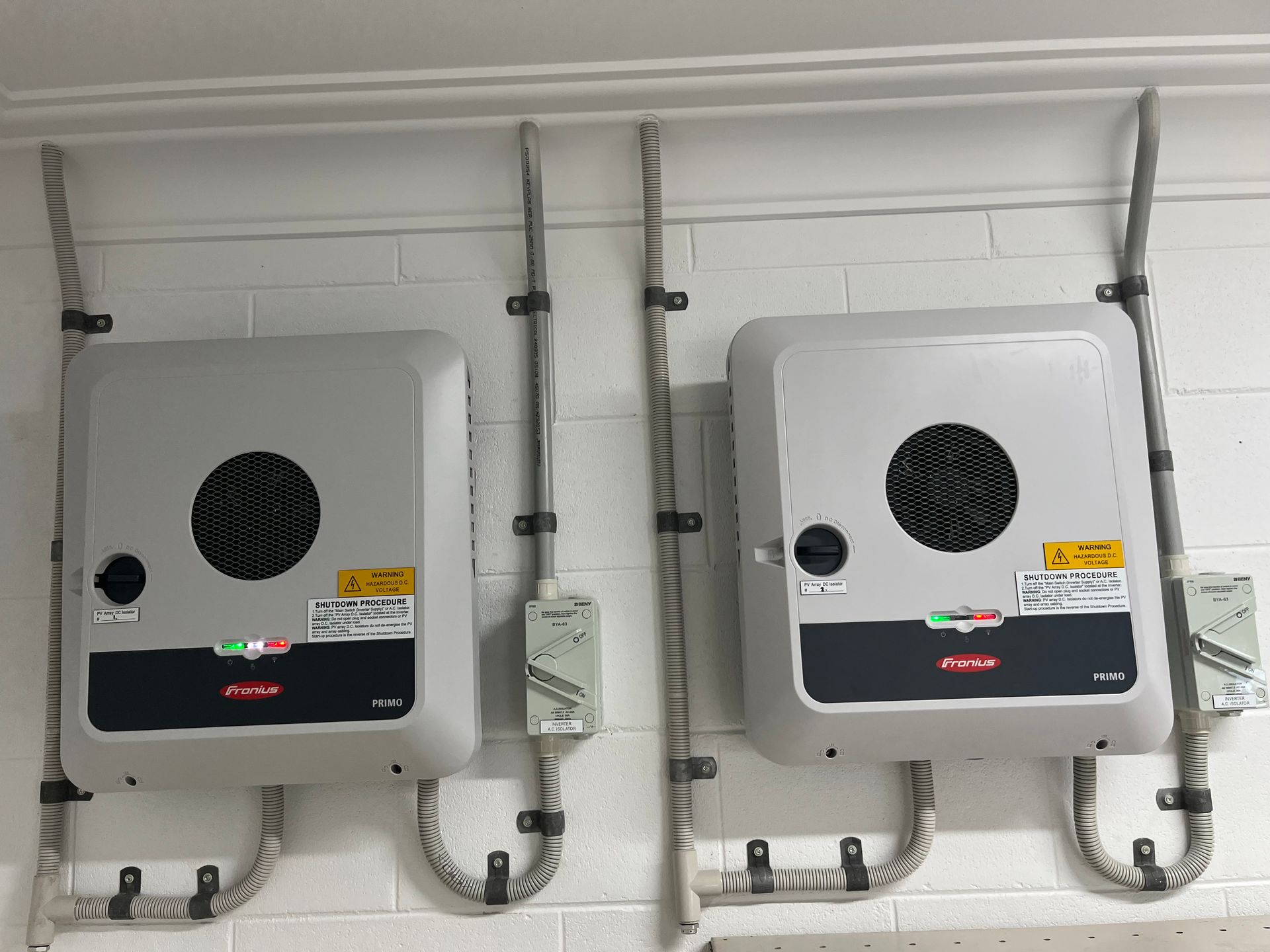 Wall-mounted White Utility Box With Pipes and a Small Control Panel — Topspark Electrical FNQ in Malanda, QLD