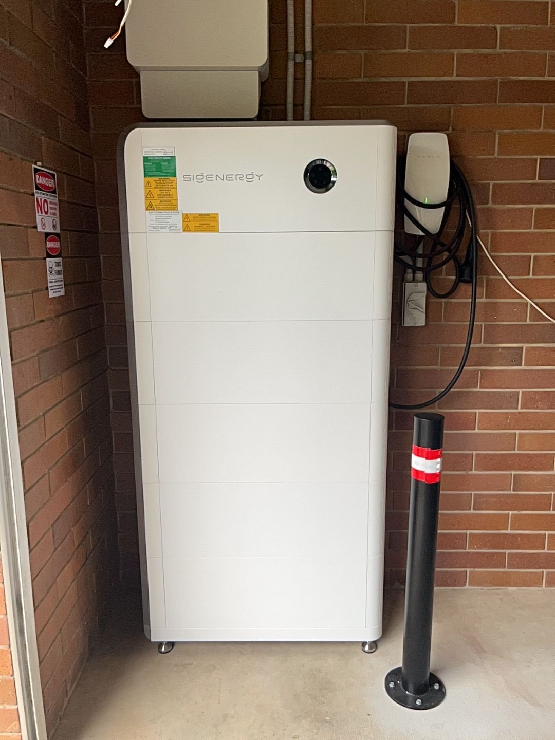 Wall-mounted White Device With a Black Cord — Topspark Electrical FNQ in Bayview Heights, QLD