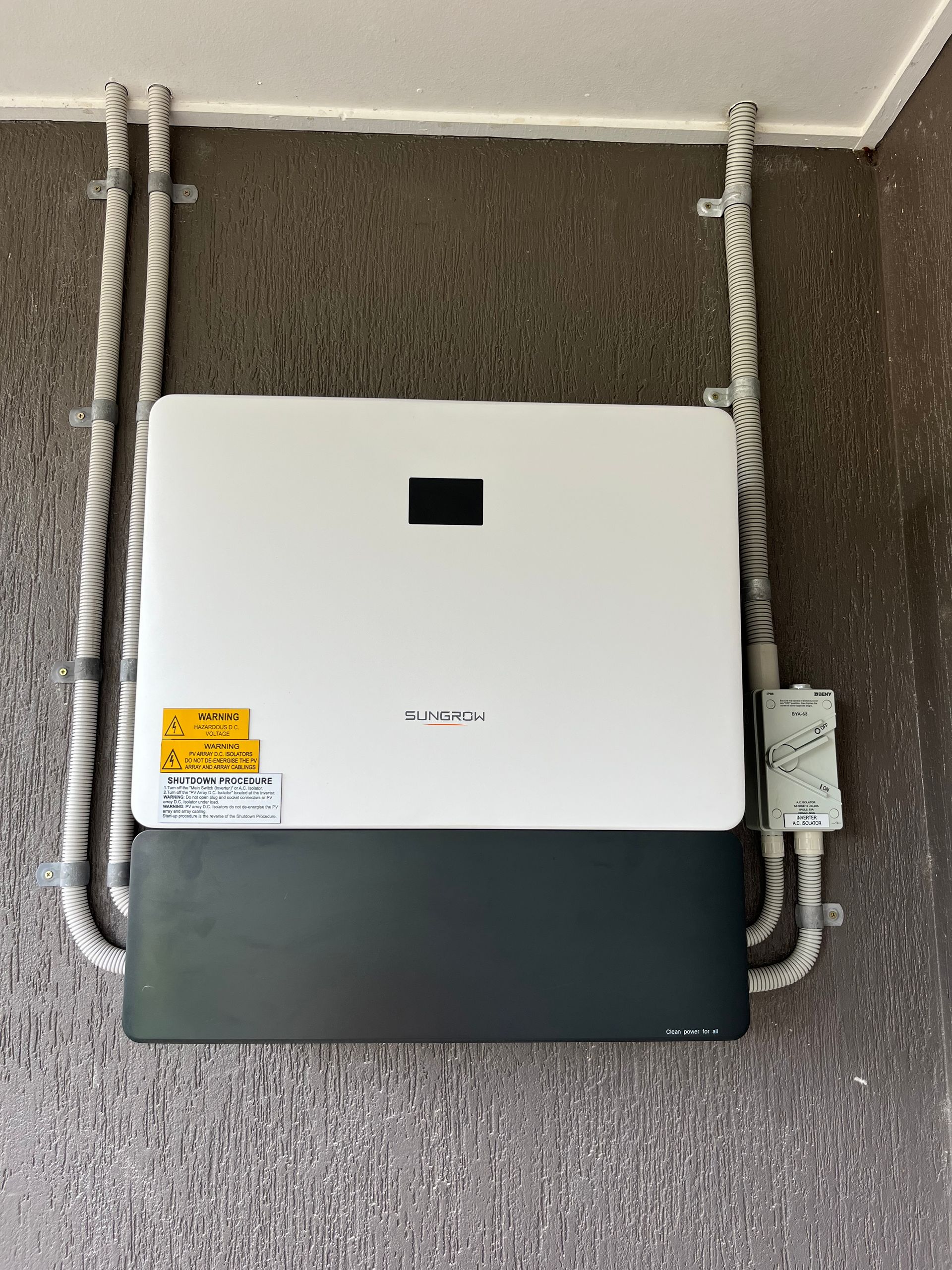 White Utility Box Mounted on House Siding With Exposed Pipes — Topspark Electrical FNQ in Bayview Heights, QLD