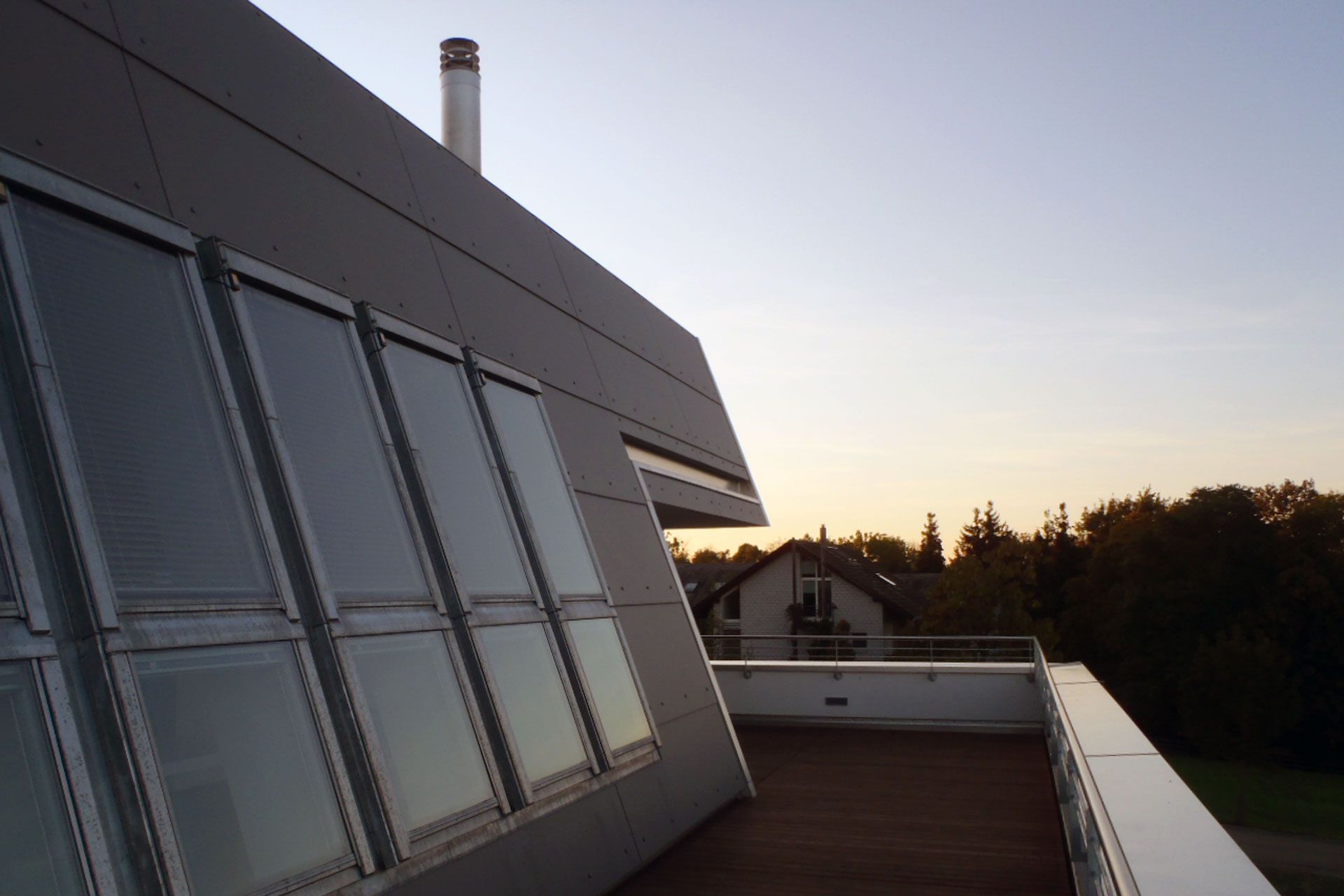 Ein Gebäude mit vielen Fenstern und einem Schornstein oben drauf