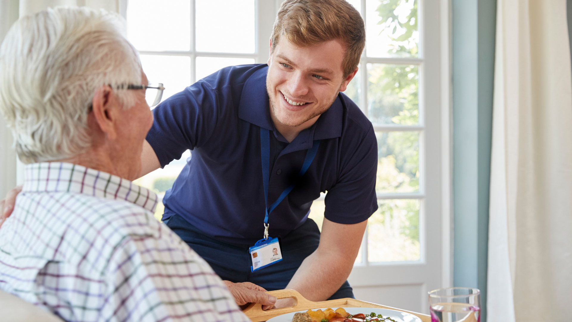Nurse taking a patient's blood pressure with a stethoscope in a medical setting.