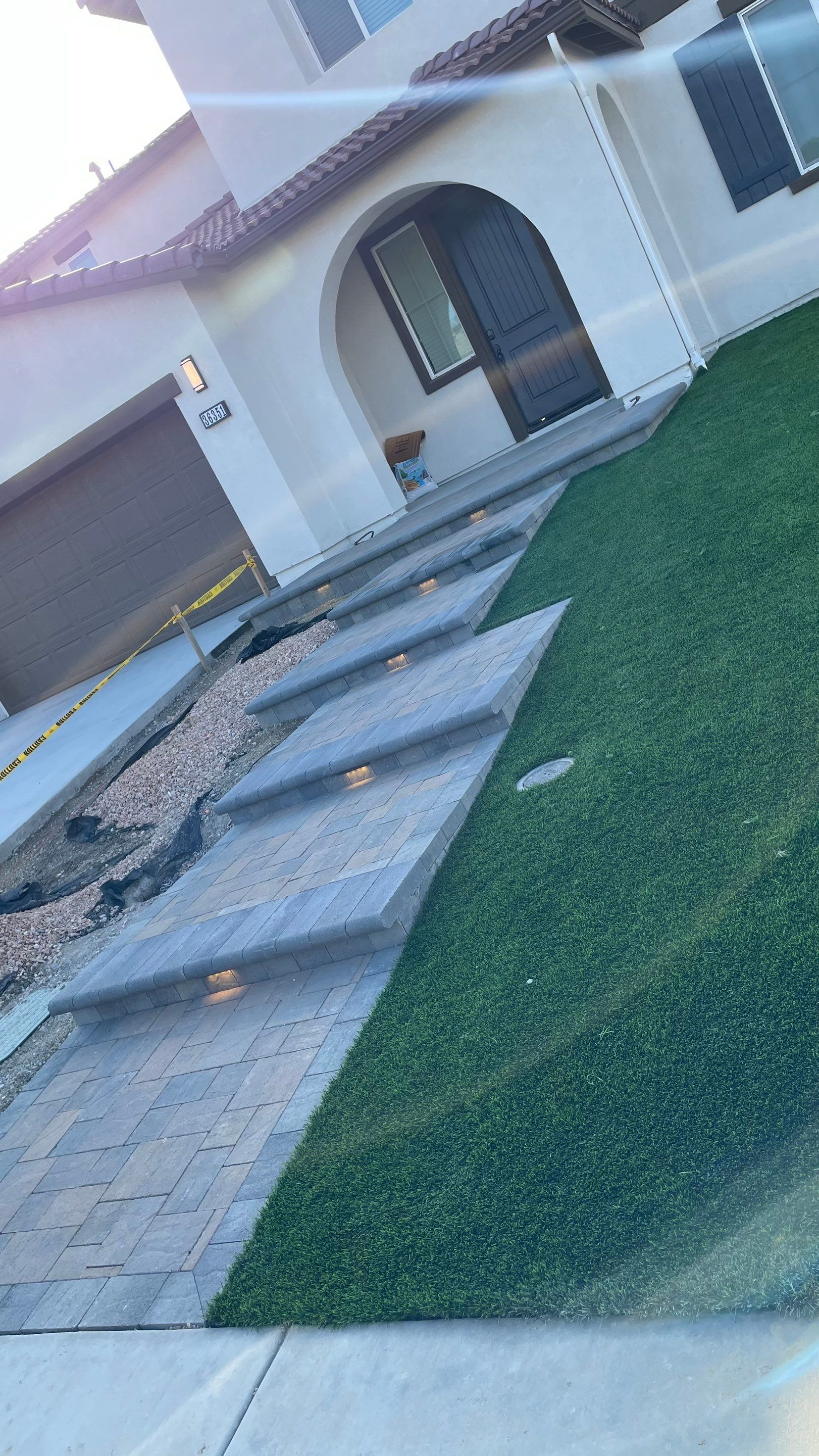 House exterior with steps and grass leading to front door.