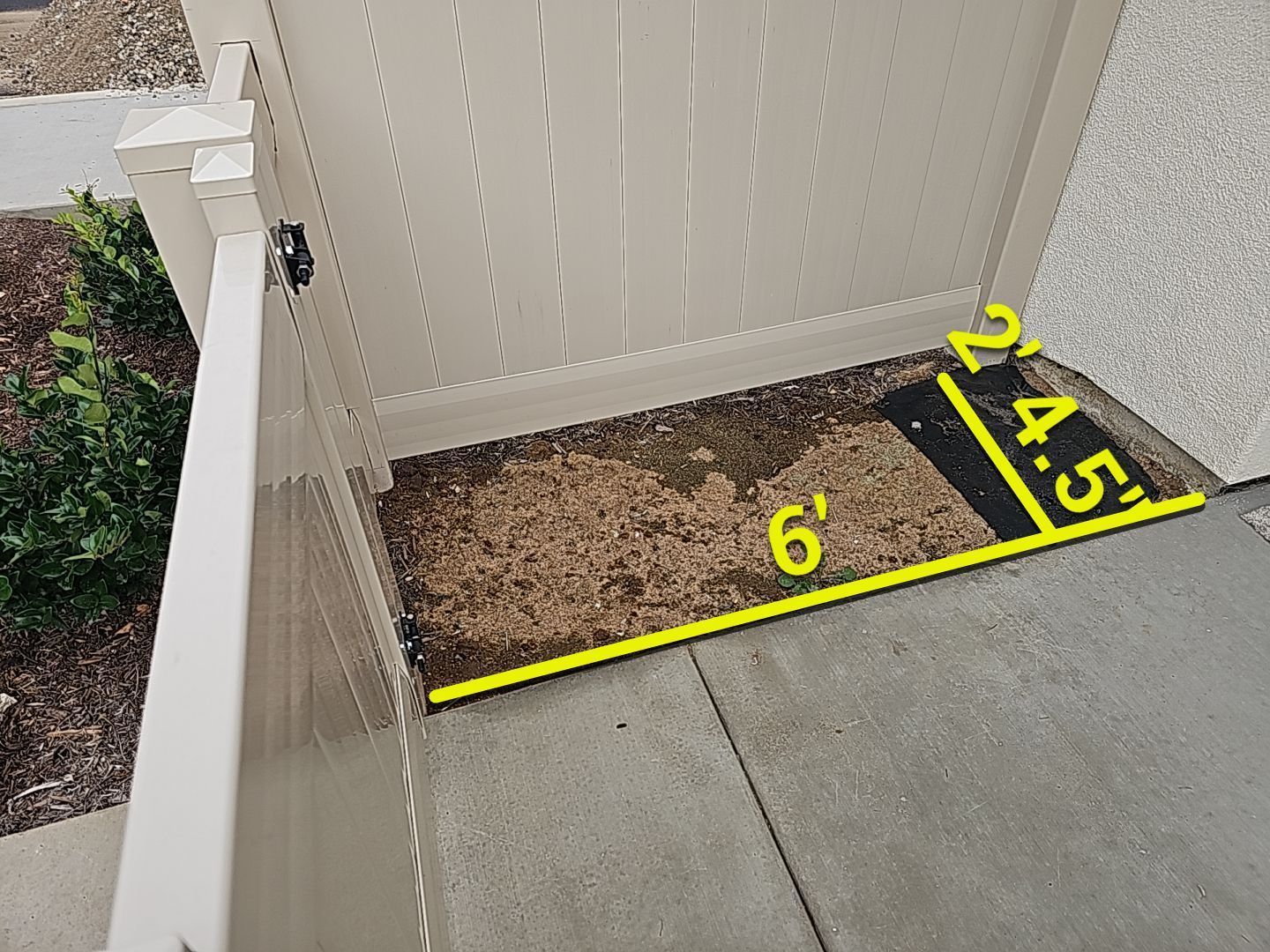 A small garden bed against a fence, with dimensions of 6', 4.5', and 2'.