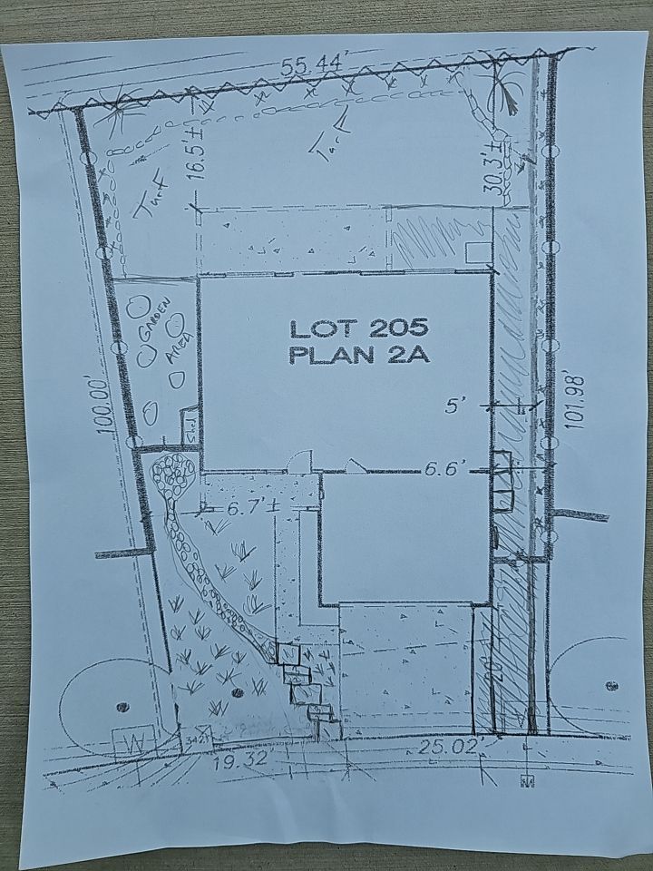 Architectural plan of Lot 205. Shows building footprint, landscaping, and property lines with dimensions.