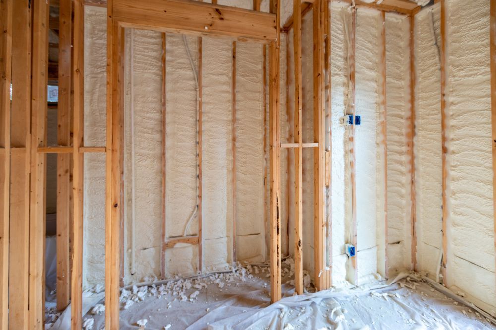 Framed room with exposed studs and spray foam insulation during construction