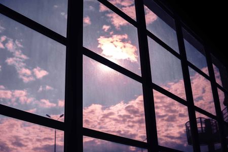 The sun is reflected in the windows of a building