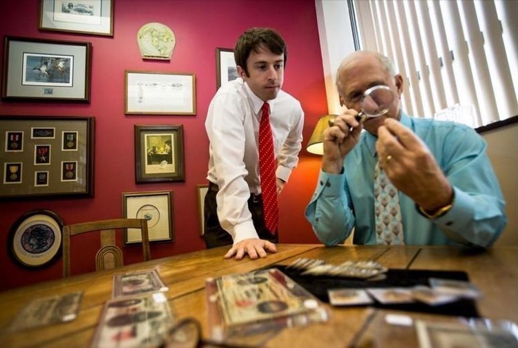 Doug and Austin Mattox reviewing coins