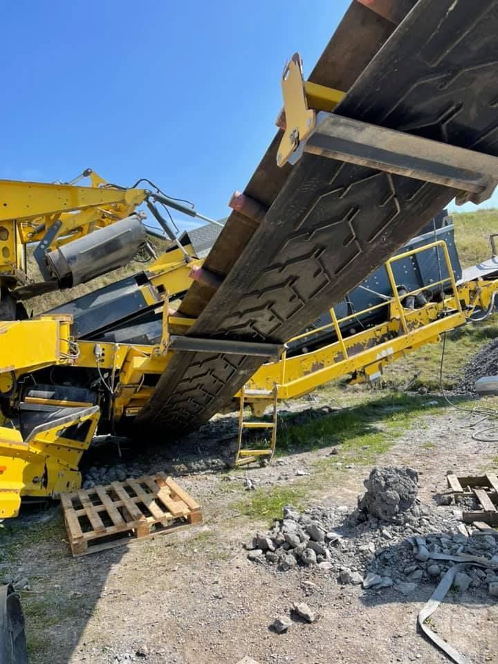 A Large Yellow Machine Is Sitting on Top of A Dirt Field — Conveyor Maintenance Services In Ayr, QLD