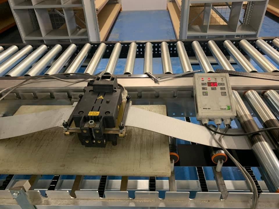 A Conveyor Belt with A Machine on Top of It — Conveyor Maintenance Services In Innisfail, QLD