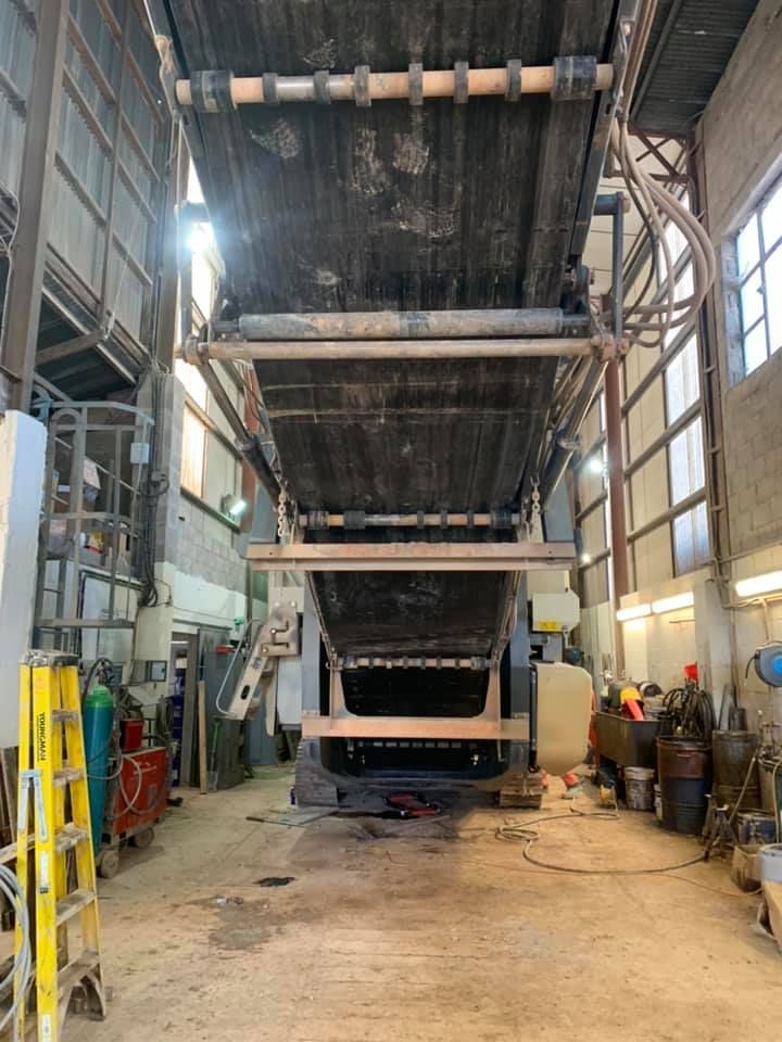 A Large Machine Is Sitting in A Large Room in A Factory — Conveyor Maintenance Services In Charters Towers, QLD