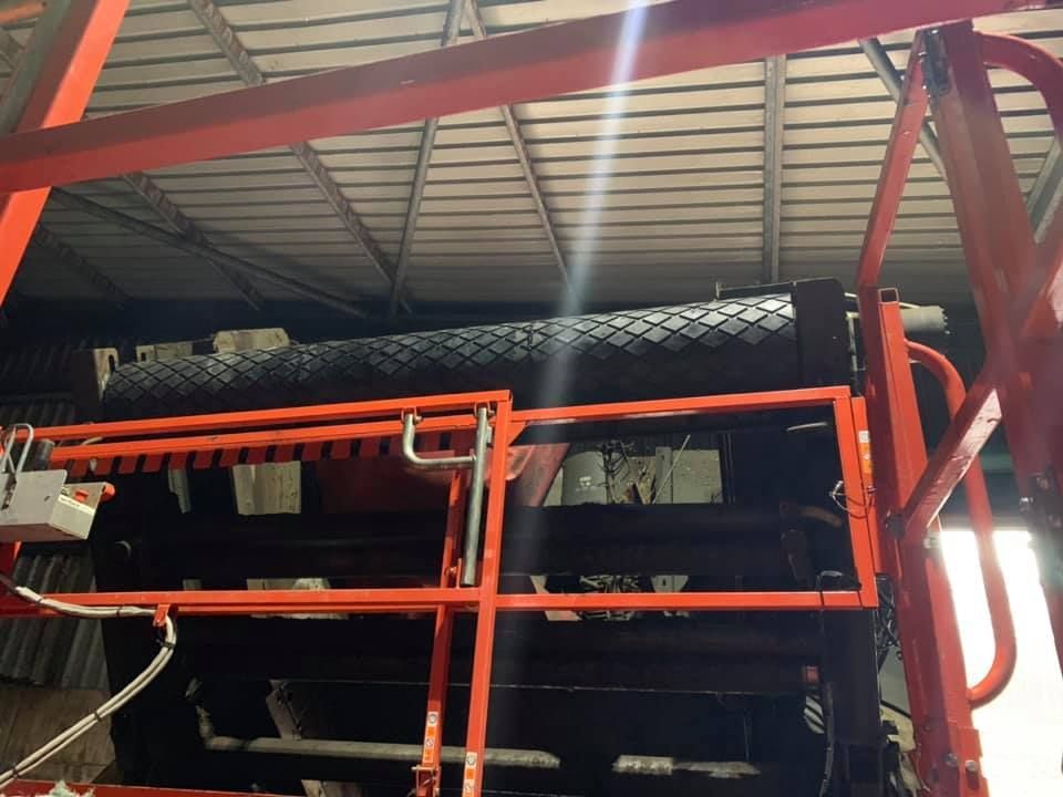 Black Rolled Belts With Orange Steel Bars — Conveyor Maintenance Services In Mount Isa, QLD