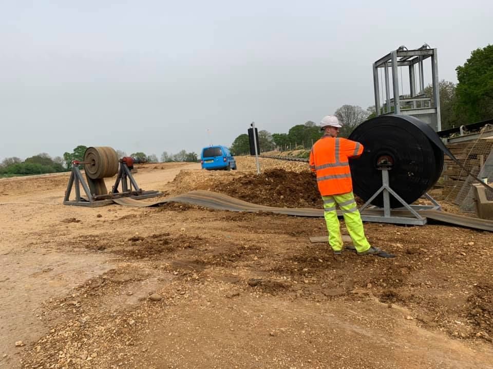 Man Working On The Big Rolled Rubber Belts — Conveyor Maintenance Services In Bohle, QLD