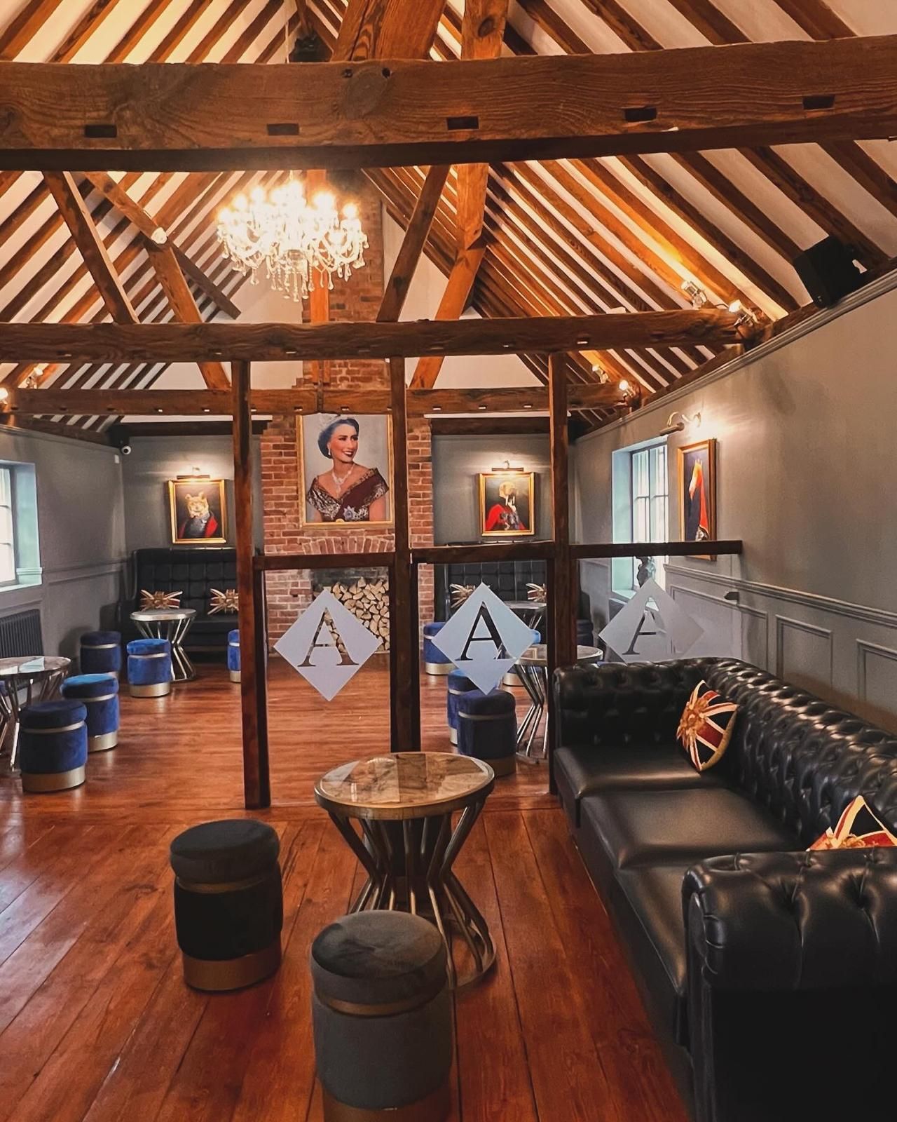 Bar interior with black and white checkered floor, dark bar, and liquor display.