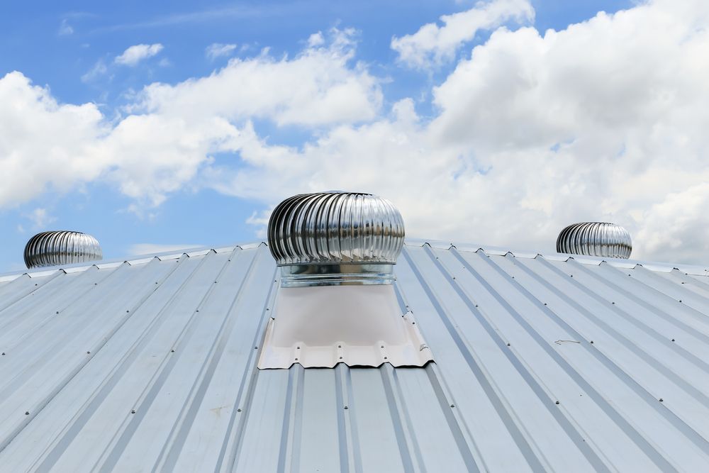 A Roof With A Fan On It And A Blue Sky In The Background — Posty’s Roofing In Proserpine, QLD 