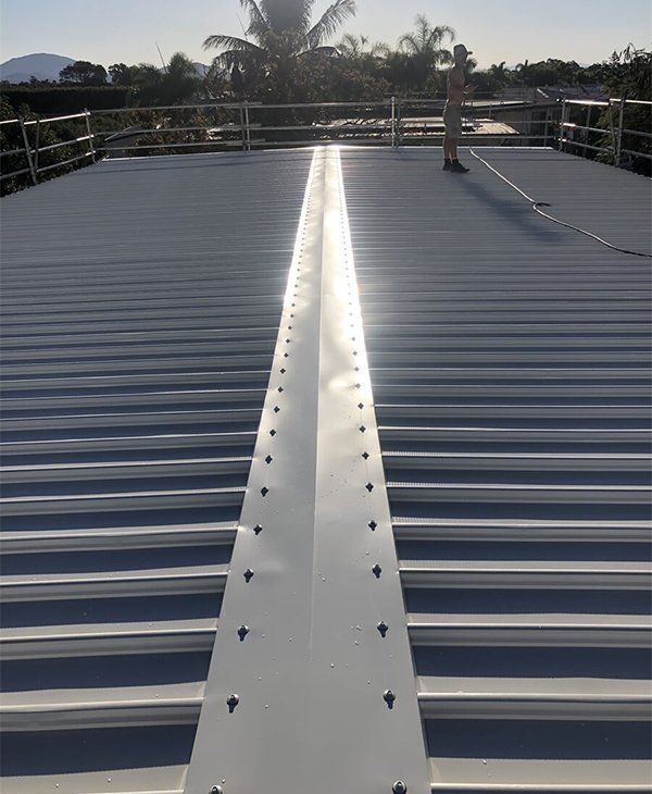 A Roof With A White Stripe On It — Posty’s Roofing In Airlie Beach, QLD