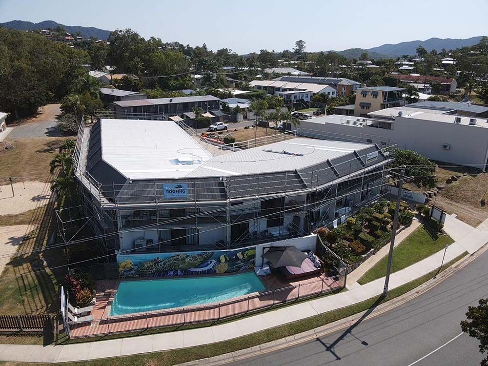 An Aerial View Of A Building With A Road In Front Of It — Posty’s Roofing In Airlie Beach, QLD