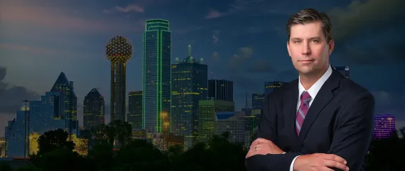 News anchor in a suit before a city skyline at dusk