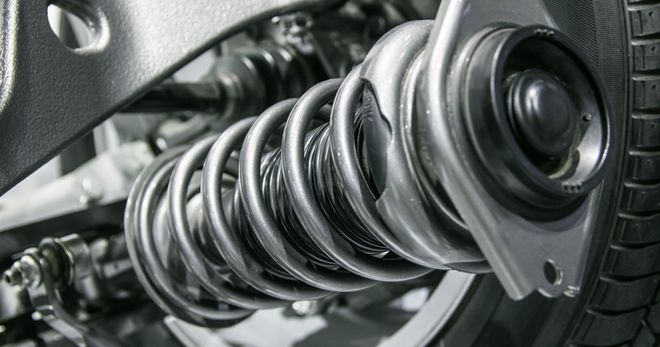 A close up of a shock absorber on a car.