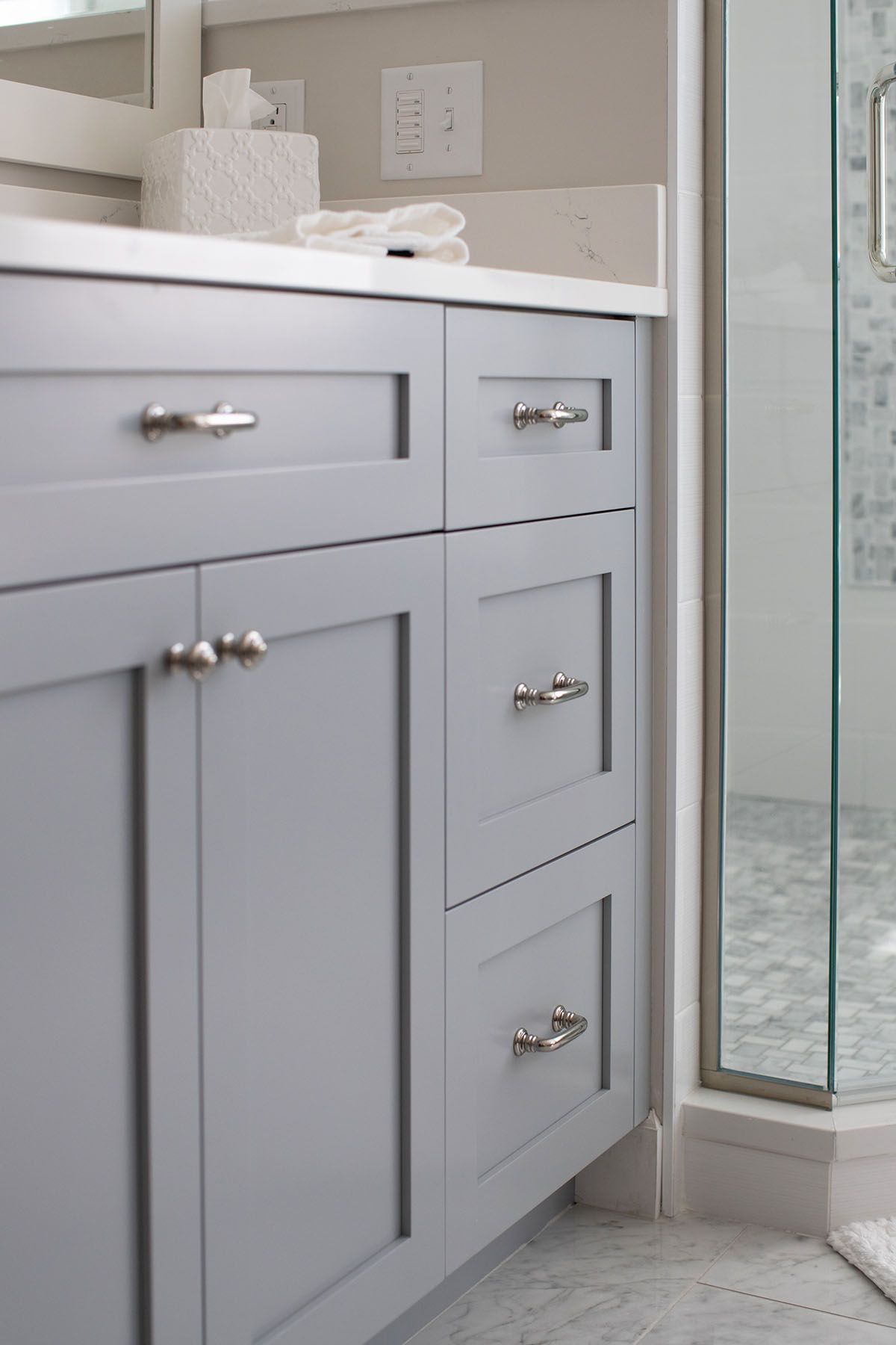 A Bathroom Vanity with Gray Cabinets and Drawers